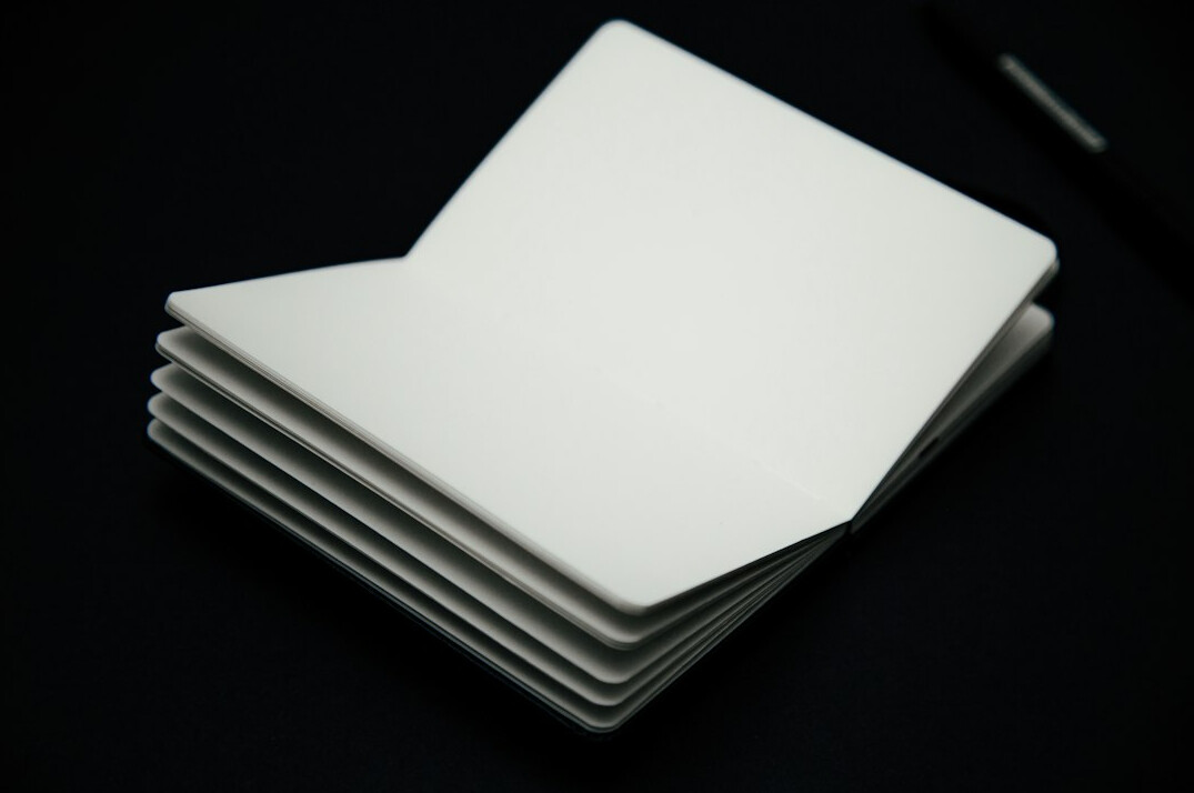 Stack of paper documents and pen on a desk